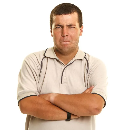 A man frowning with his arms crossed.
