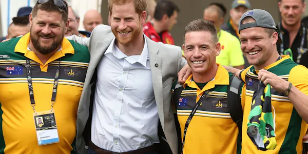 Prince Harry stands with a group of Invictus Games athletes.