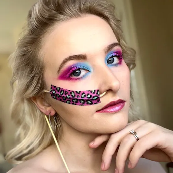 Megan Fisher, 'The Chronic Makeup Artist', has blue and pink eye shadow to match her colourful NG tube tape.