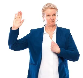 A woman with her hand raised, and pointing to herself with her other hand.