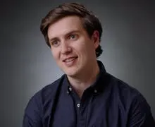 Hireup CEO Jordan O'Reilly is looking like he's takling to someone to his right. He's wearing an dark blue shirt