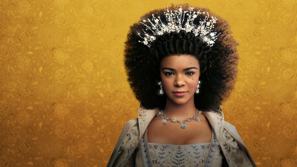 Queen Charlotte is a character in a Netflix series, which this image promotes. A dark-skinned woman dressed in regal attire and wearing a crown is featured in font of a yellow background.