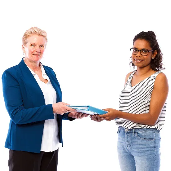 A woman handing a document to another woman