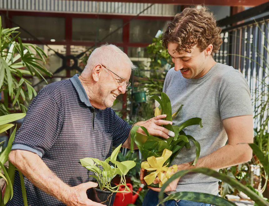 Hireup aged care client Frank with his support worker Luka gardening together.