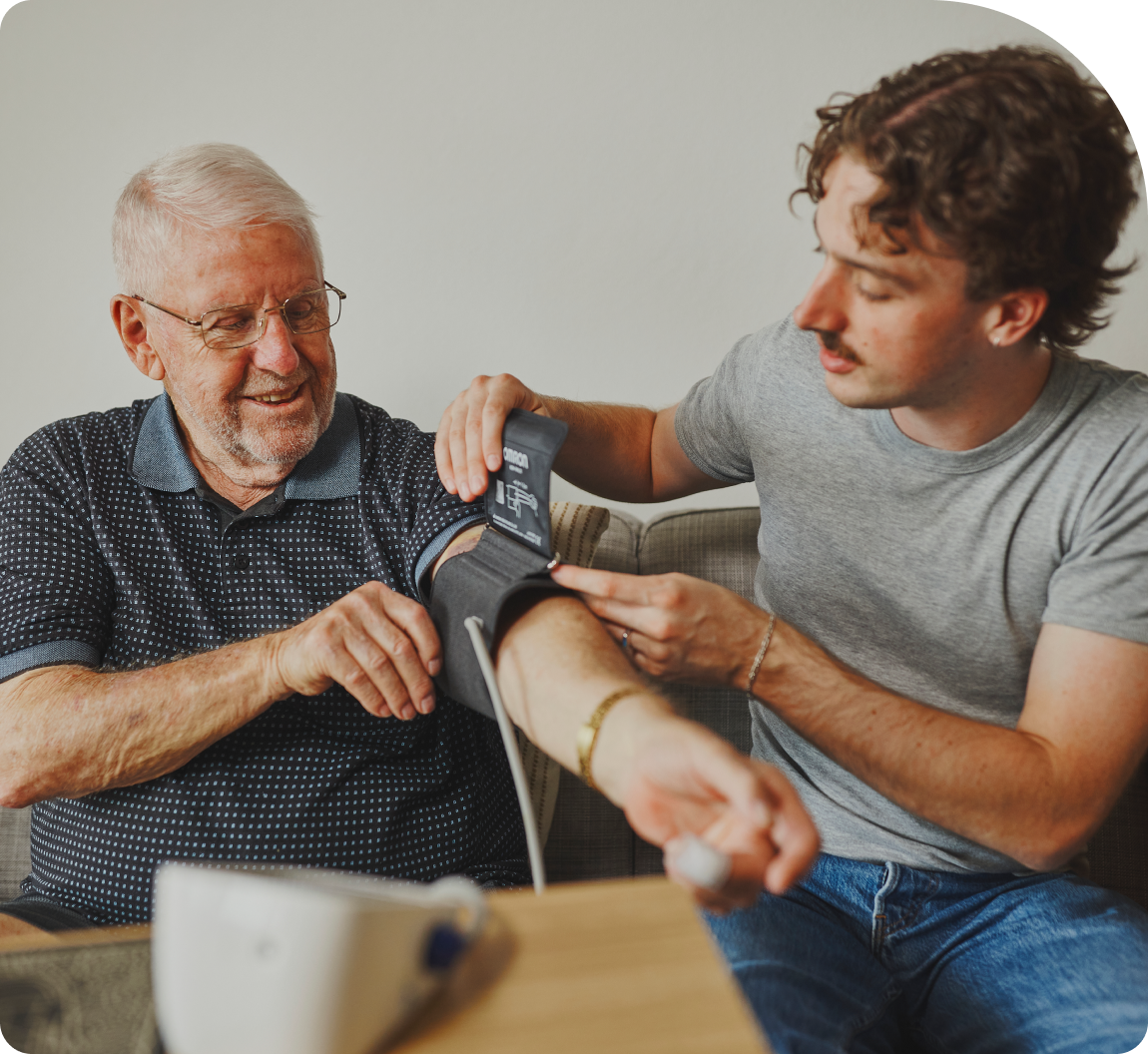 Hireup support worker Luka checks client Frank's blood pressure.