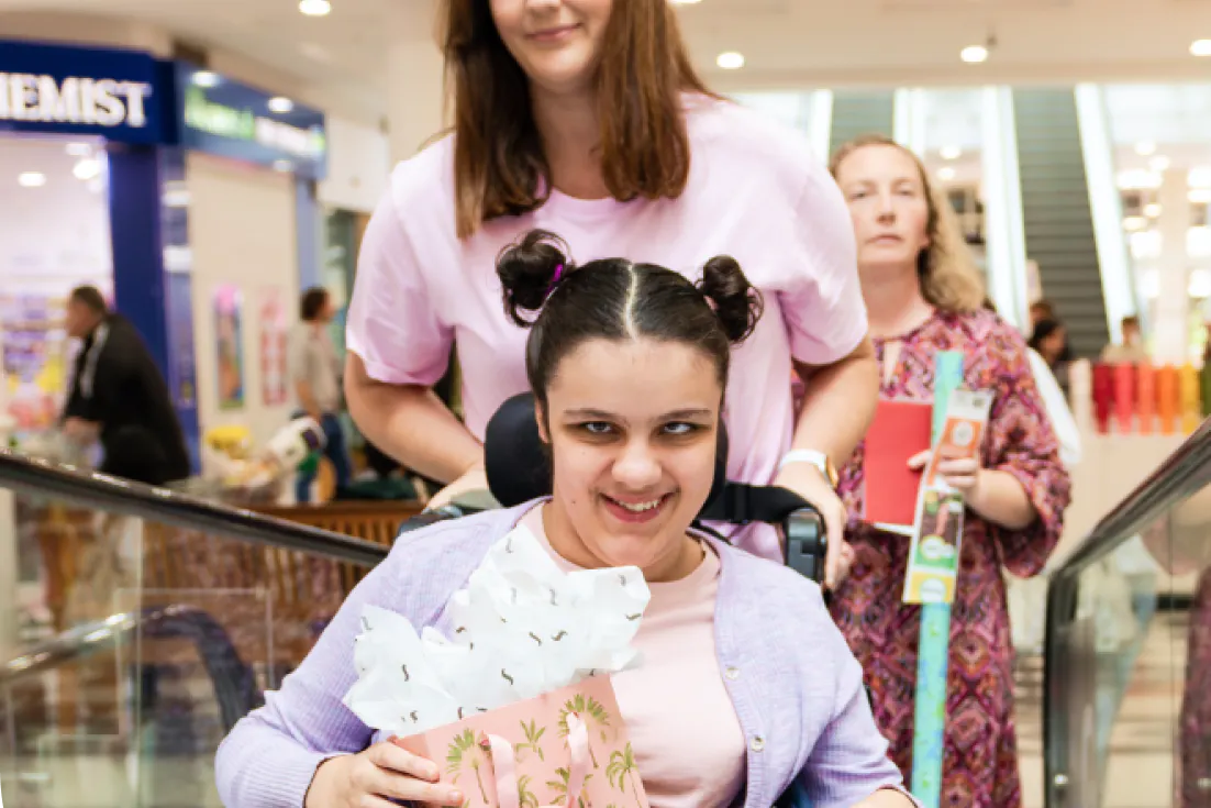 Hireup client Kia with her support worker Jess at a shopping centre.