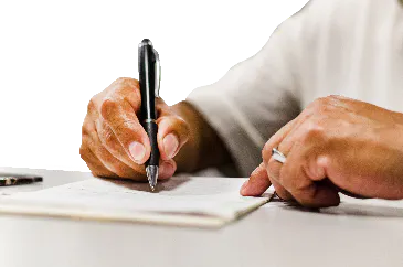 A person signing paperwork.
