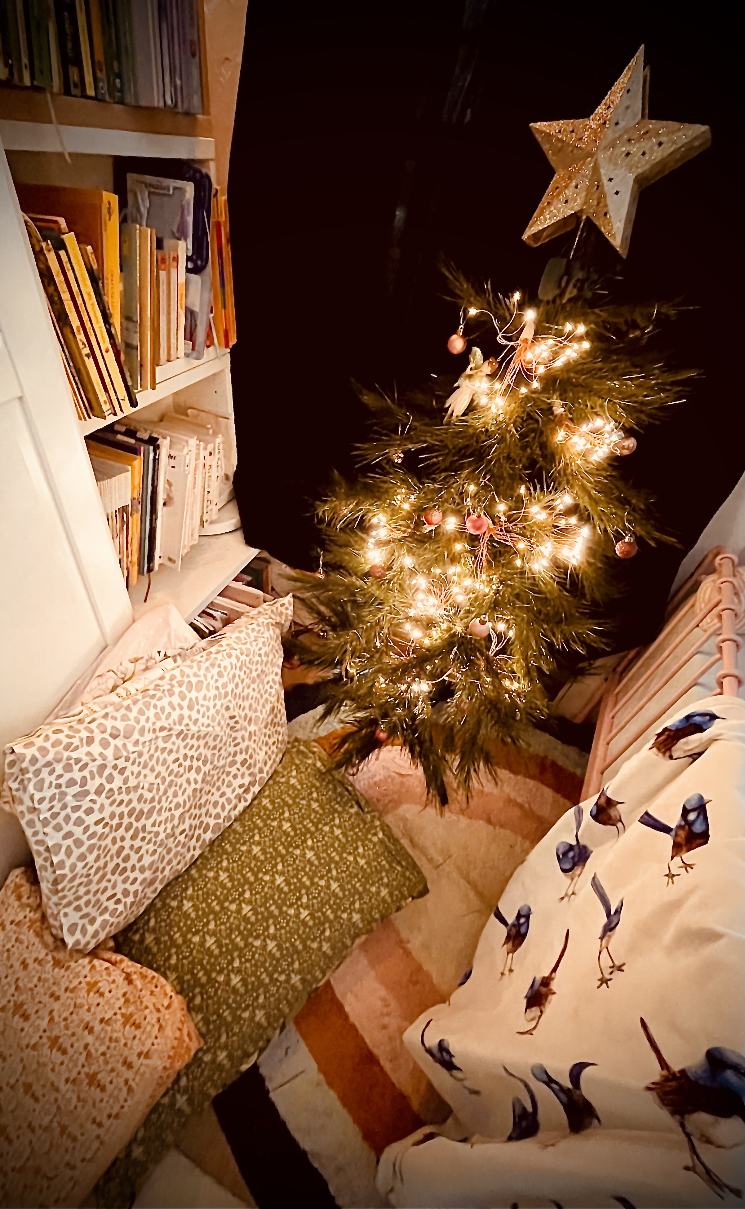 A sensory chill out zone, featuring a Christmas tree and pillows. 
