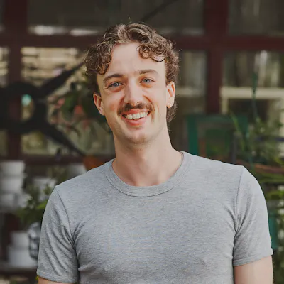 Hireup support worker Luca smiling at the camera.
