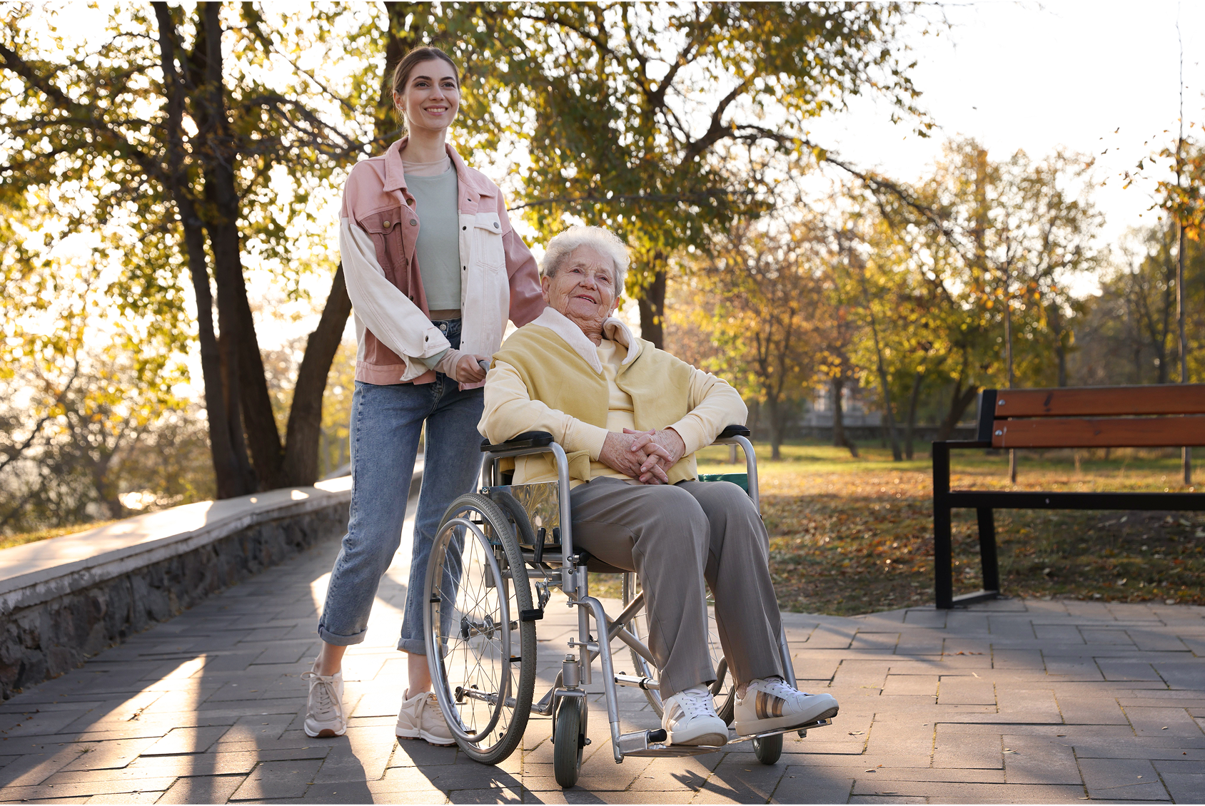 A support worker pushing a client in a wheelchair.