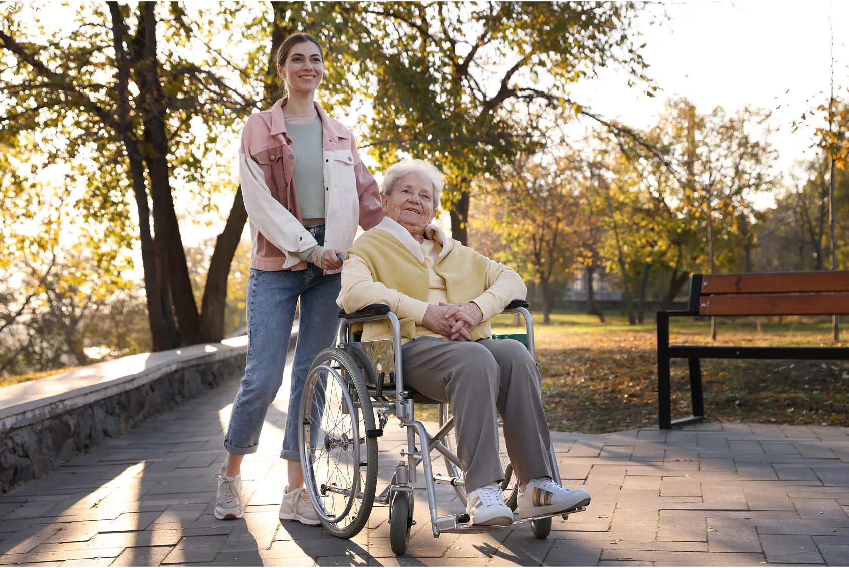 A support worker pushing a client in a wheelchair.