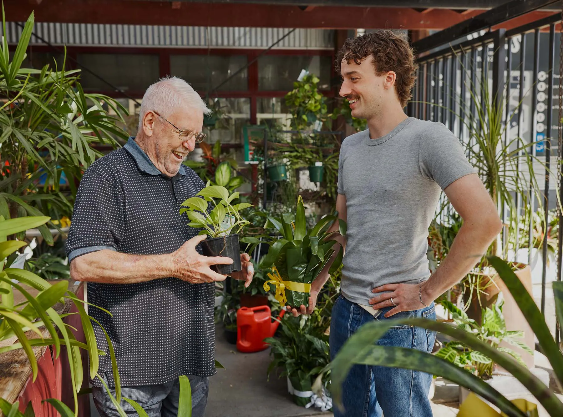 Hireup client Frank and worker Luca pick pot plants up from a nursery.