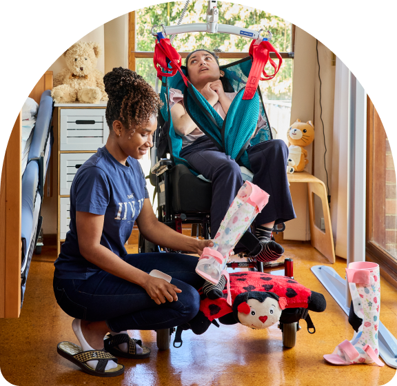 A support worker providing manual handling support to a client.