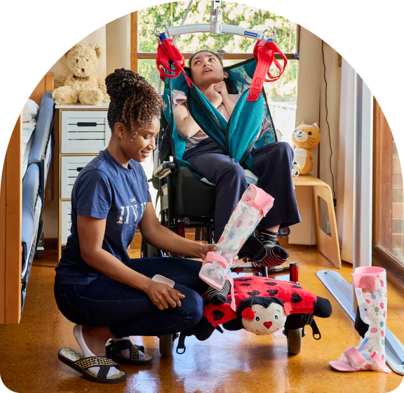 A support worker providing manual handling support to a client.