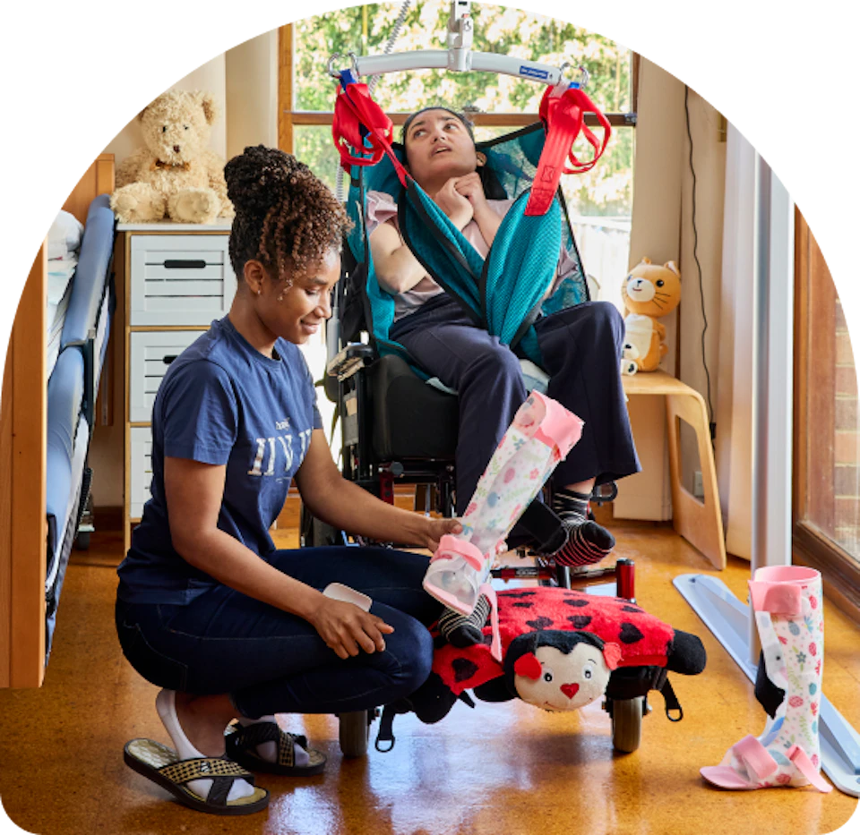 A support worker providing manual handling support to a client.