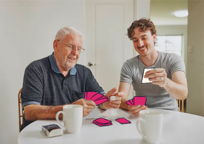 Hireup client Frank and support worker Luka playing cards together. The cards are illustrated.