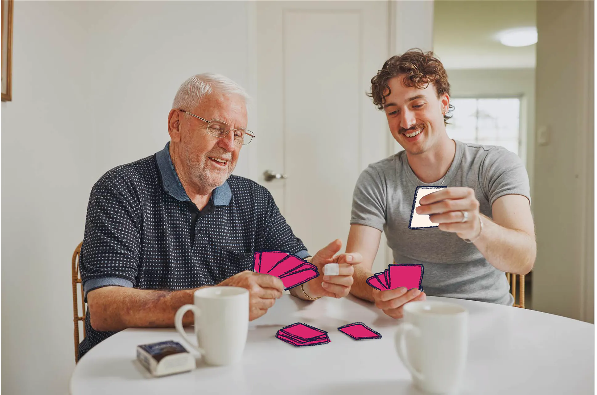 Hireup client Frank and support worker Luka playing cards together. The cards are illustrated.