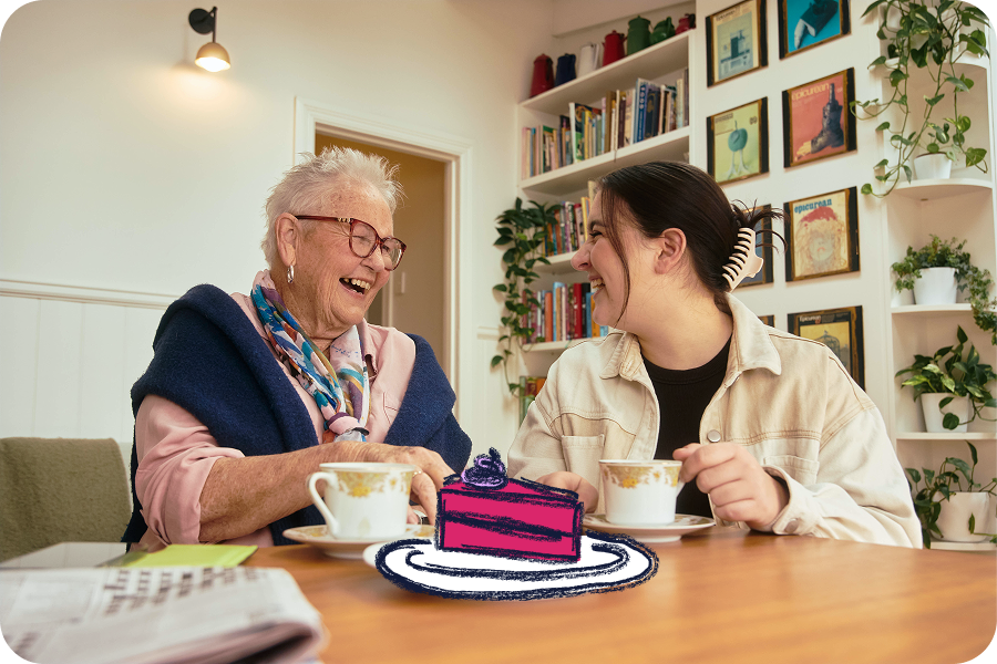 Hireup client Elsie and support worker Emma having tea and cake together.