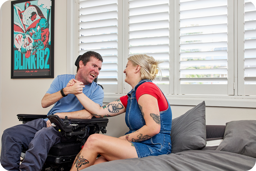 Hireup client Mick and support worker Maddy shaking hands.