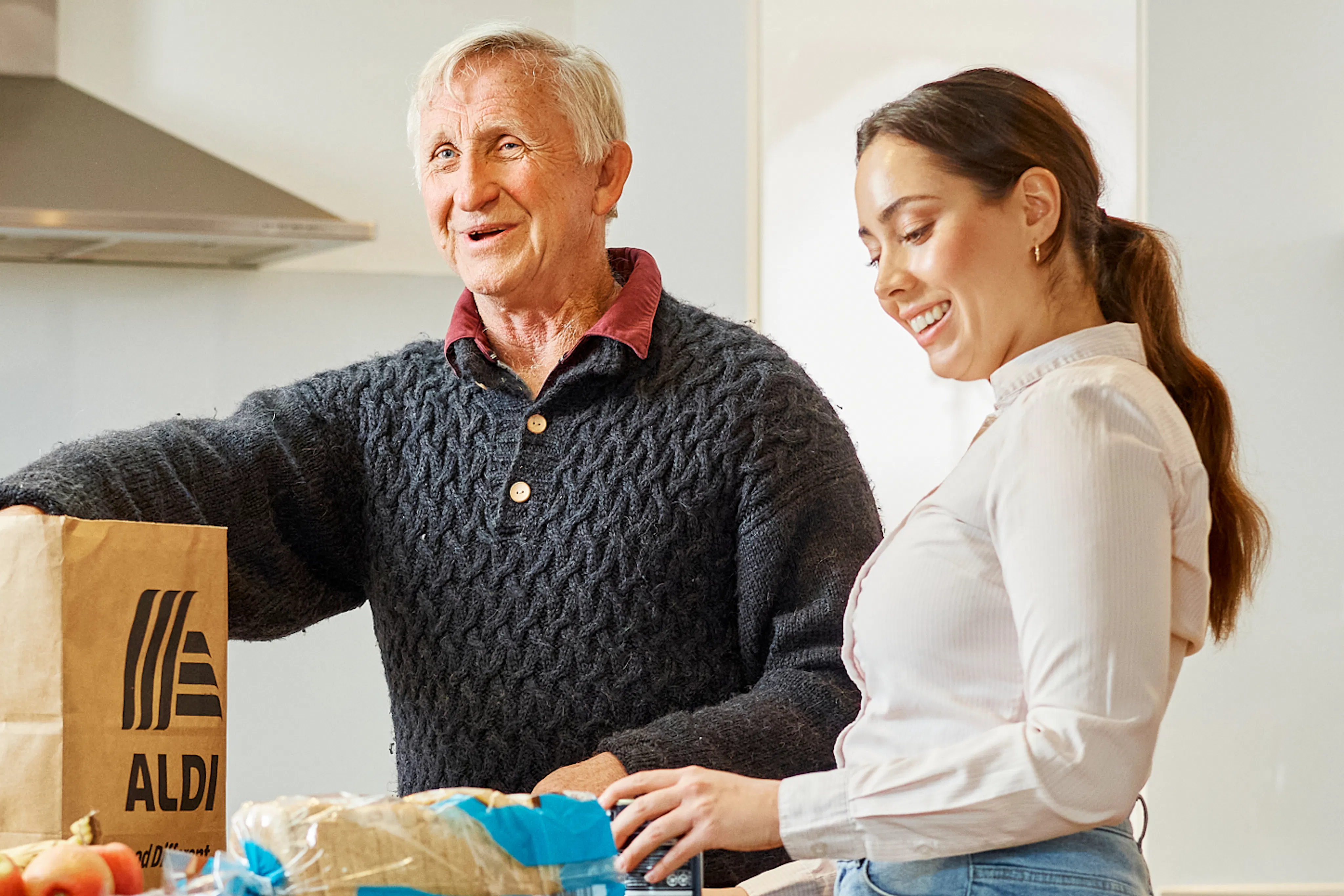 Hireup support worker Brenda helps client Dirk unpack his groceries.