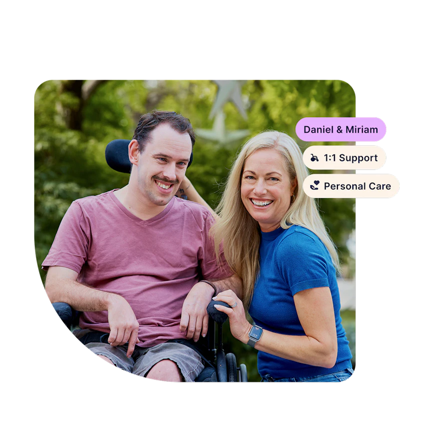 Hireup client Daniel smiles at the camera with his support worker Miriam. Tags in the corner show their names and support types, "1:1 support" and "personal care".