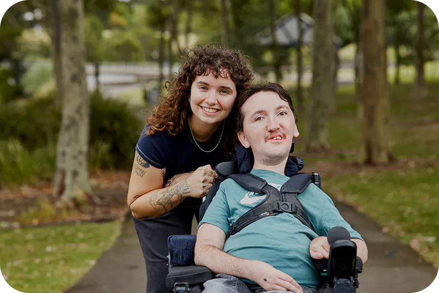 Hireup client Tom and support worker Sarah smile at the camera.