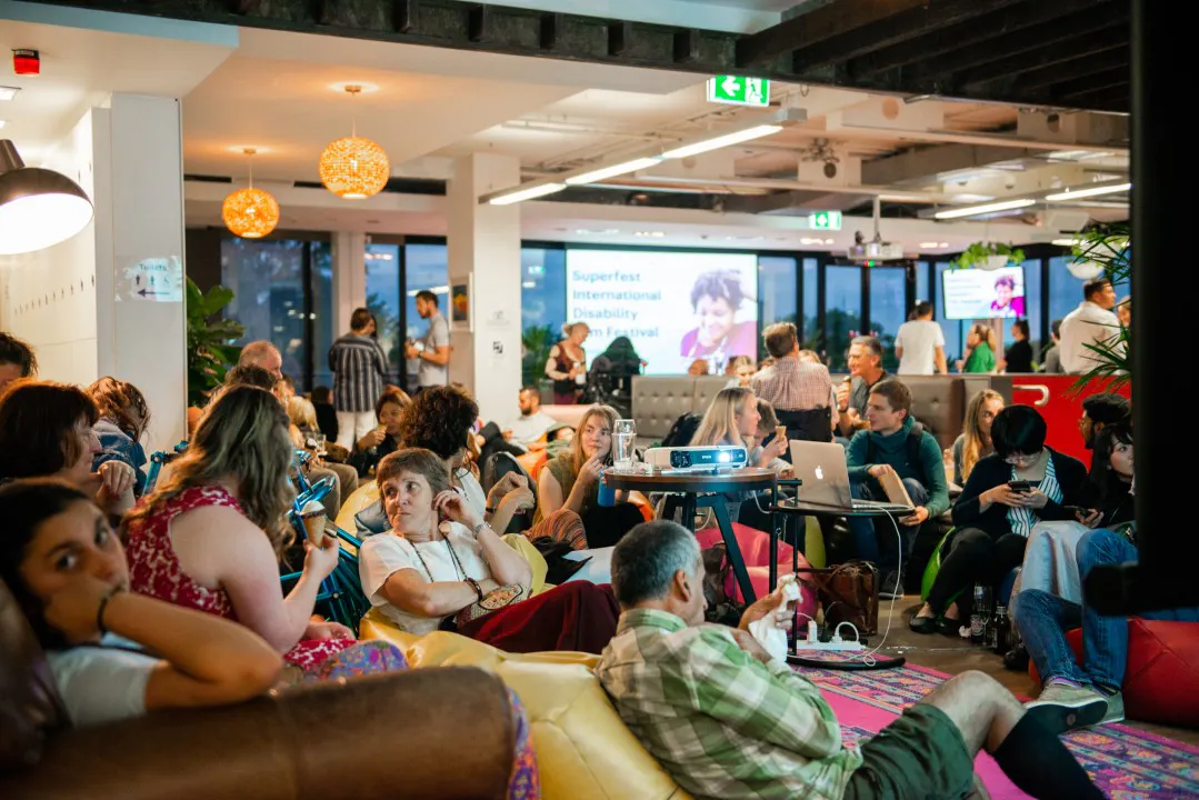 People gathered on level 3 of the Hireup office for Superfest, International Disability Film Festival