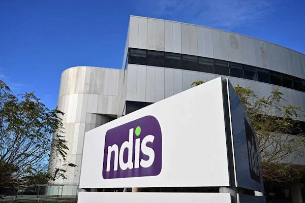 An image of the NDIS logo in front of an office building.