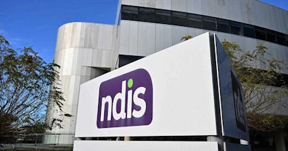An image of the NDIS logo in front of a office building.