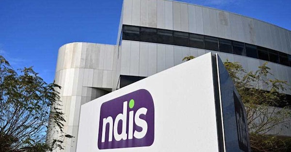 An image of the NDIS logo in front of an office building.