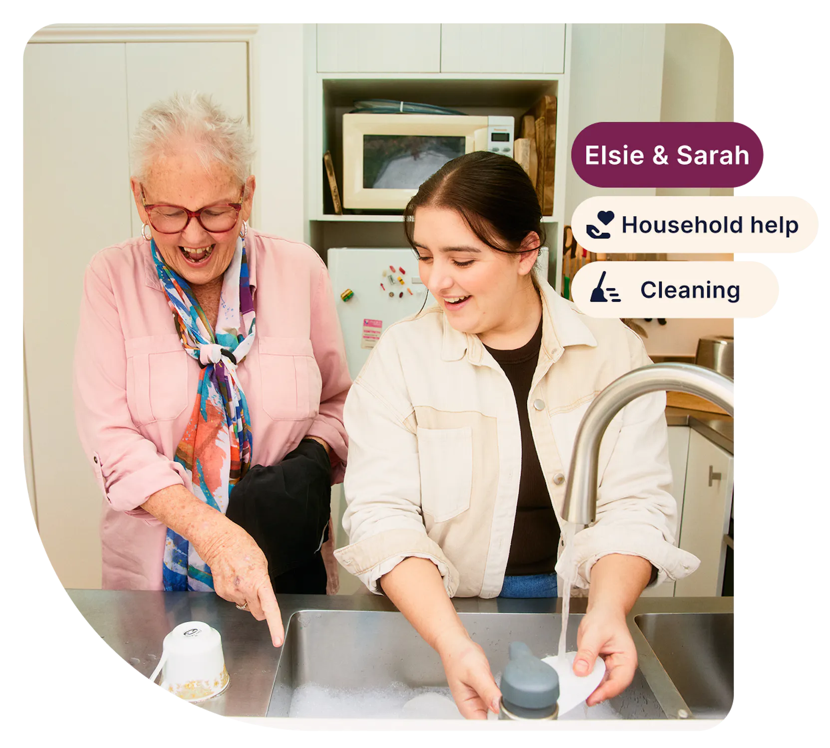 Support worker Sarah helps aged care client Elsie with the dishes. There are three tags on the right side: "Elsie and Sarah", "Household help" and "Cleaning".