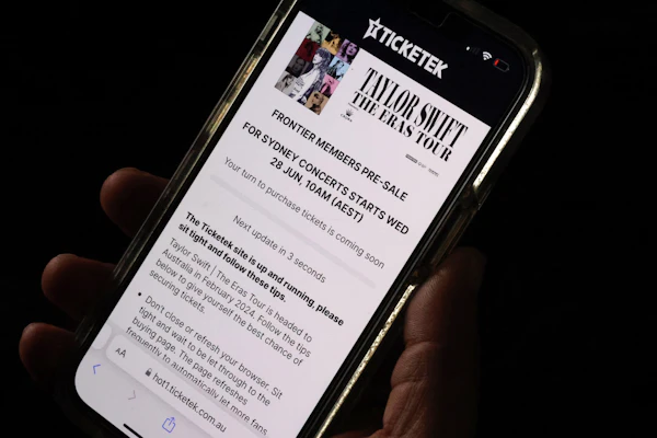 The Taylor Swift Eras Tour Ticketek ticket queuing page is seen on a mobile device.