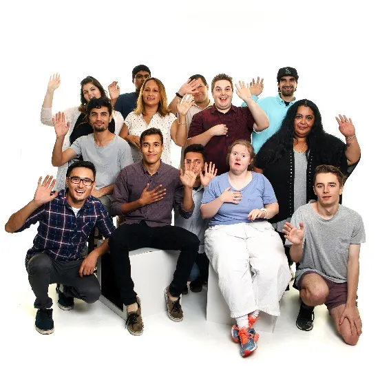A group of people standing together, waving and cheering
