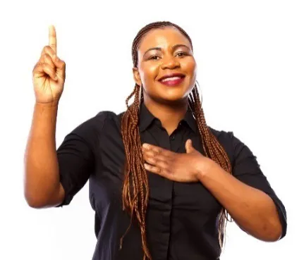 A woman with one hand raised and the other on her chest.