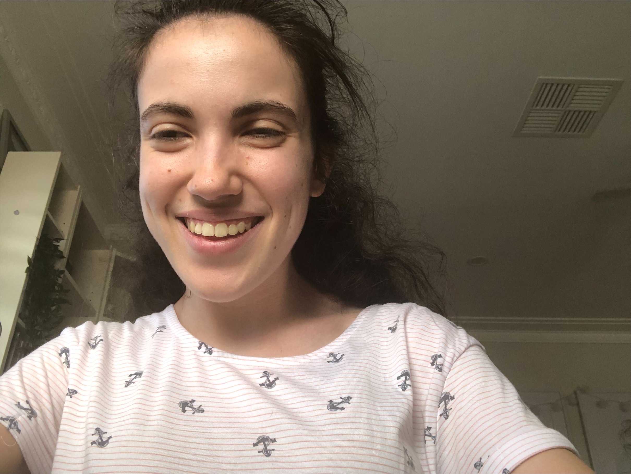 Hannah is looking and the camera and smiling in a selfie photo. 