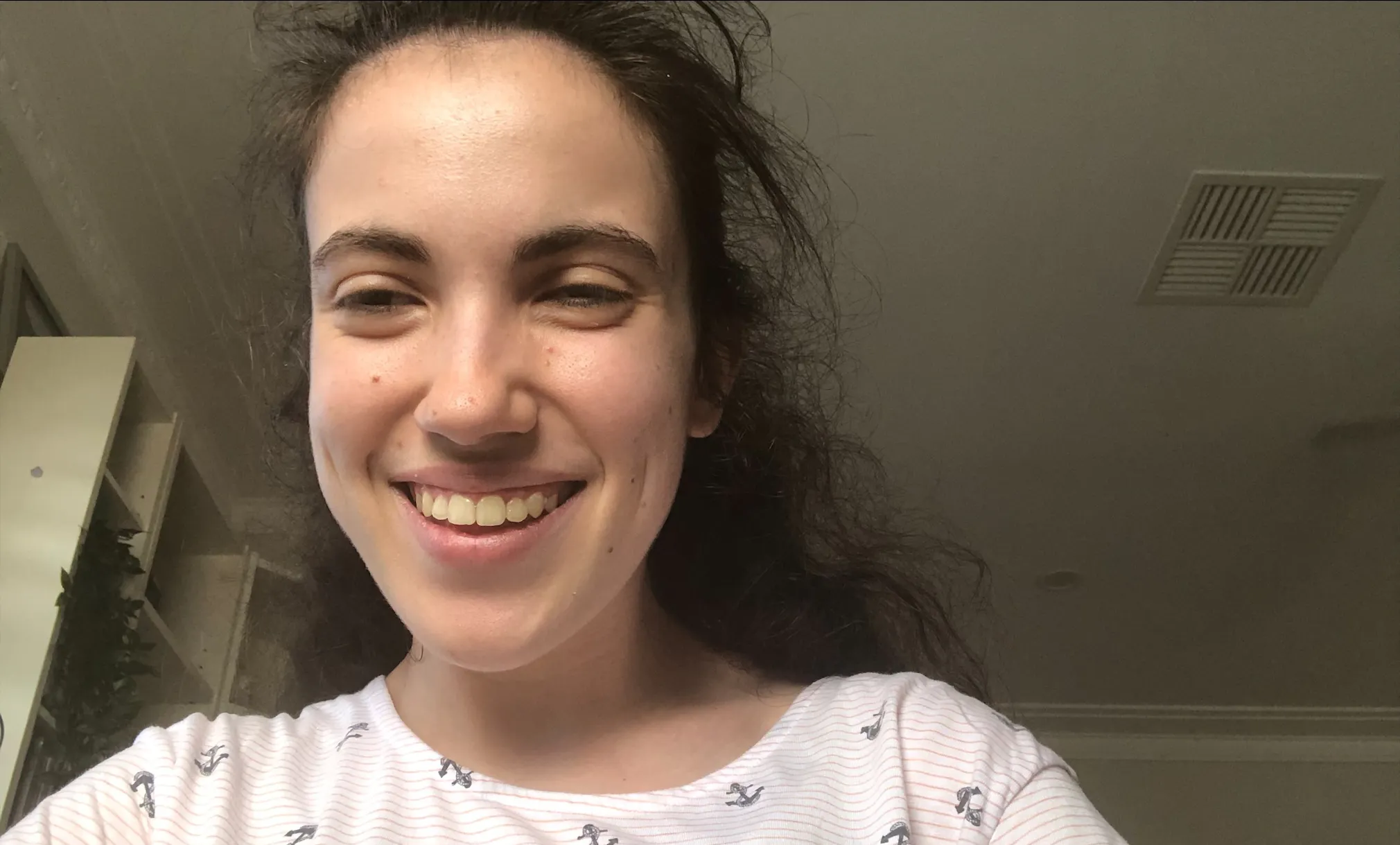 Hannah is looking and the camera and smiling in a selfie photo.