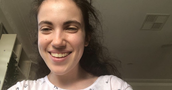 Hannah is looking and the camera and smiling in a selfie photo.