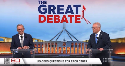 Anthony Albanese and Scott Morrison are standing at podiums in front of a picture of Parliament House and the words "The Great Debate"