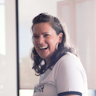 Harriet Dwyer, Hireup's Director of Impact & Innovation looks in the distance smiling.