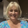 Podcaster and sleep consultant Mandy Hose has a blonde bob and wears a colourful polkadot top. She smiles at the camera.