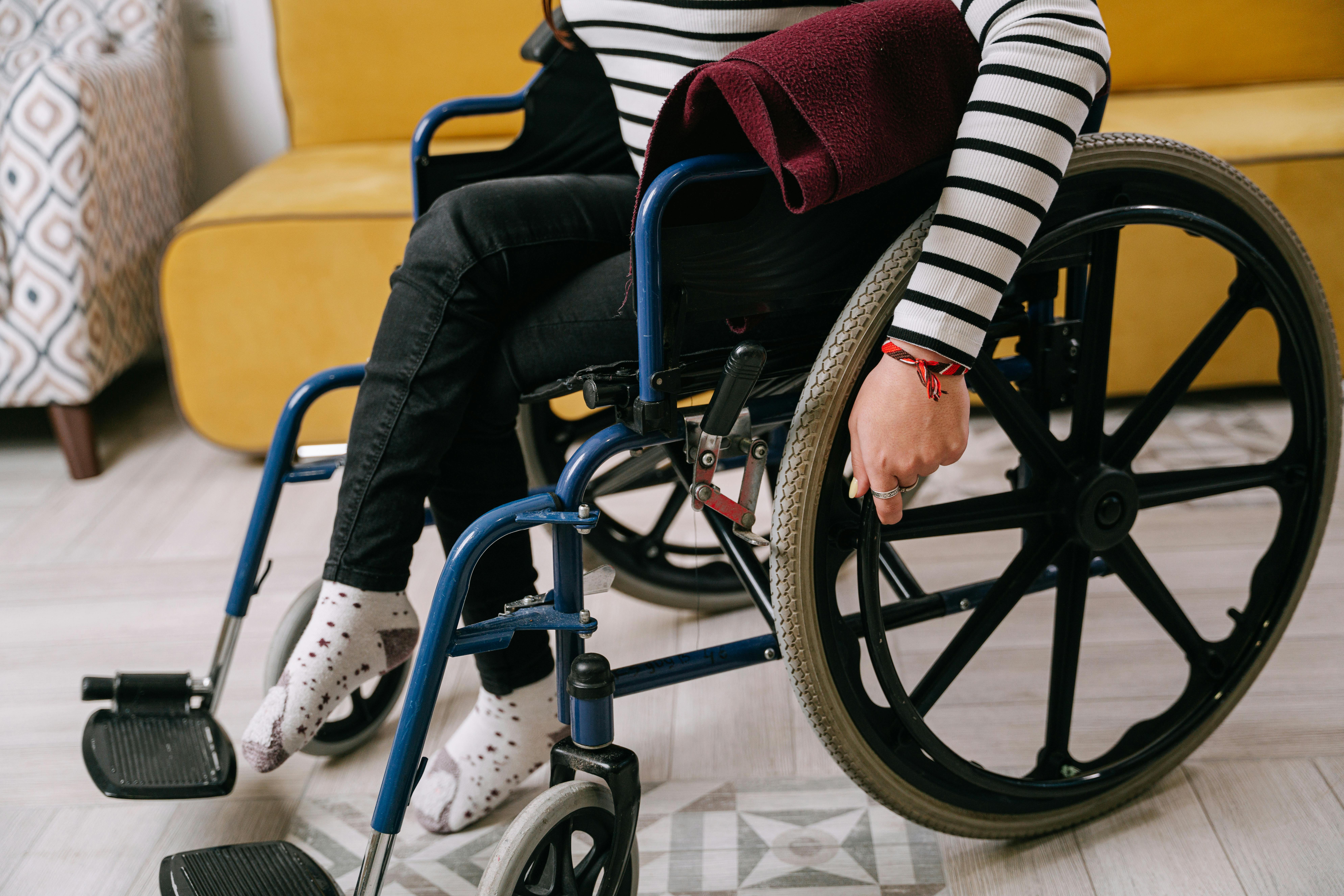 A person adjusts their wheelchair.
