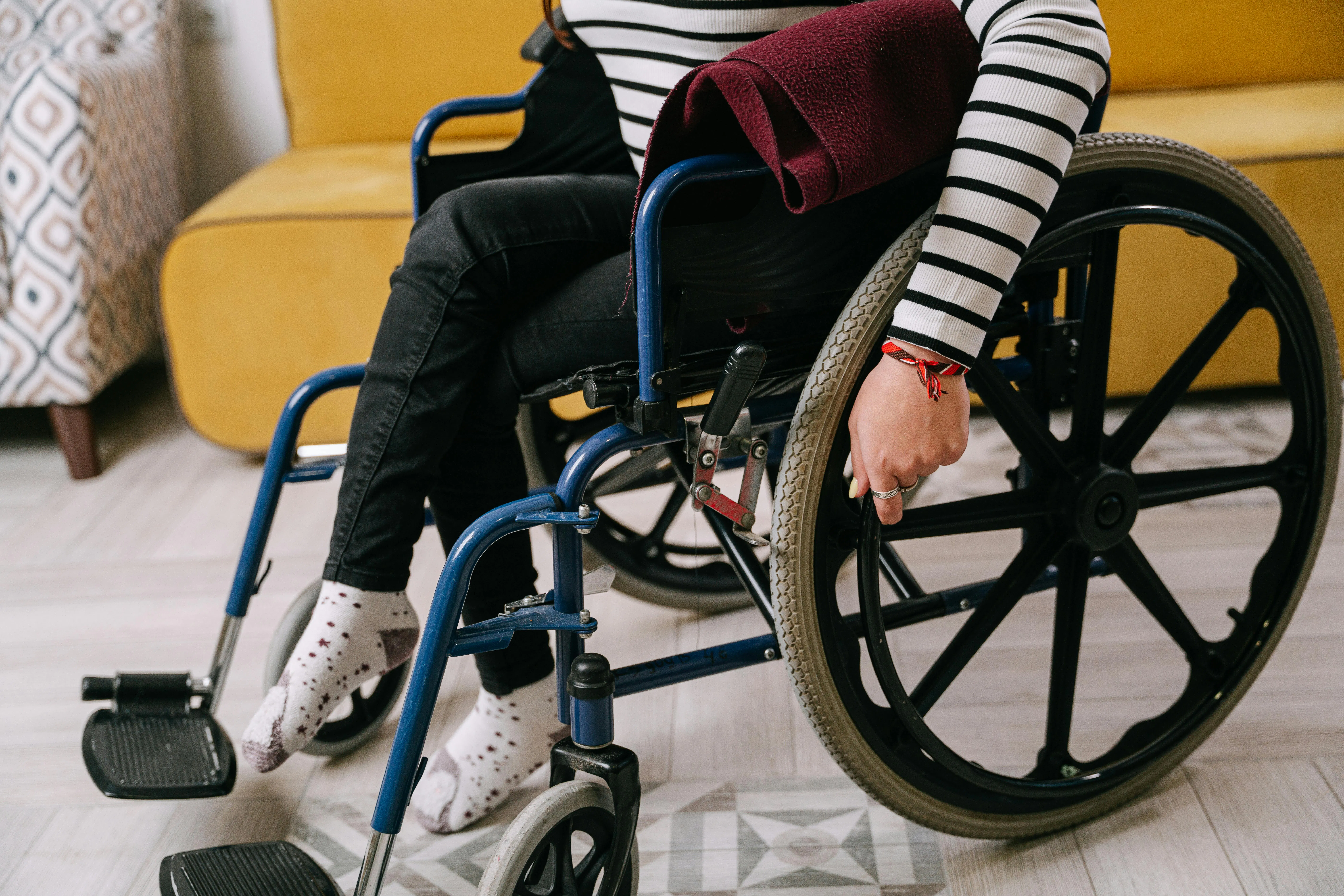 A person adjusts their wheelchair.