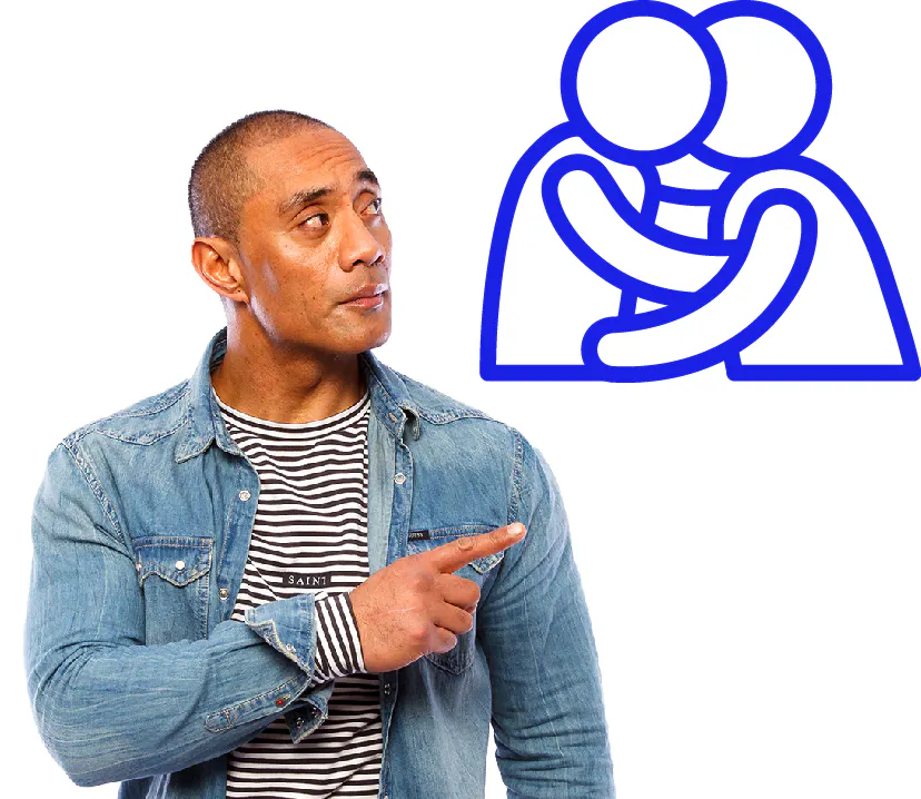 A person pointing at 2 people holding each other and kissing.