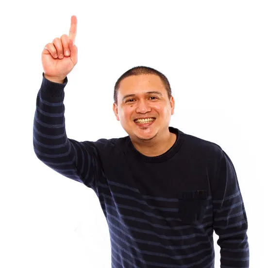 A man smiling and raising his hand