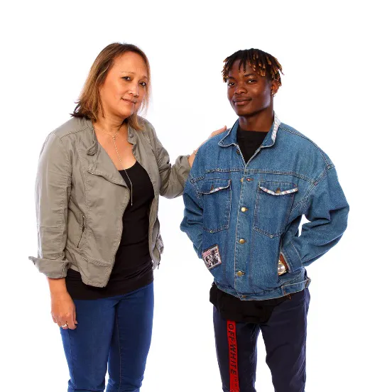 A woman supporting a man with a hand on his shoulder