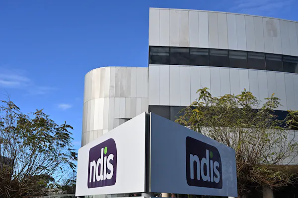 Image shows: Exterior of NDIS building with an NDIS sign in the foreground. 