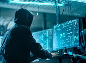 A hacker stealing information from a computer.