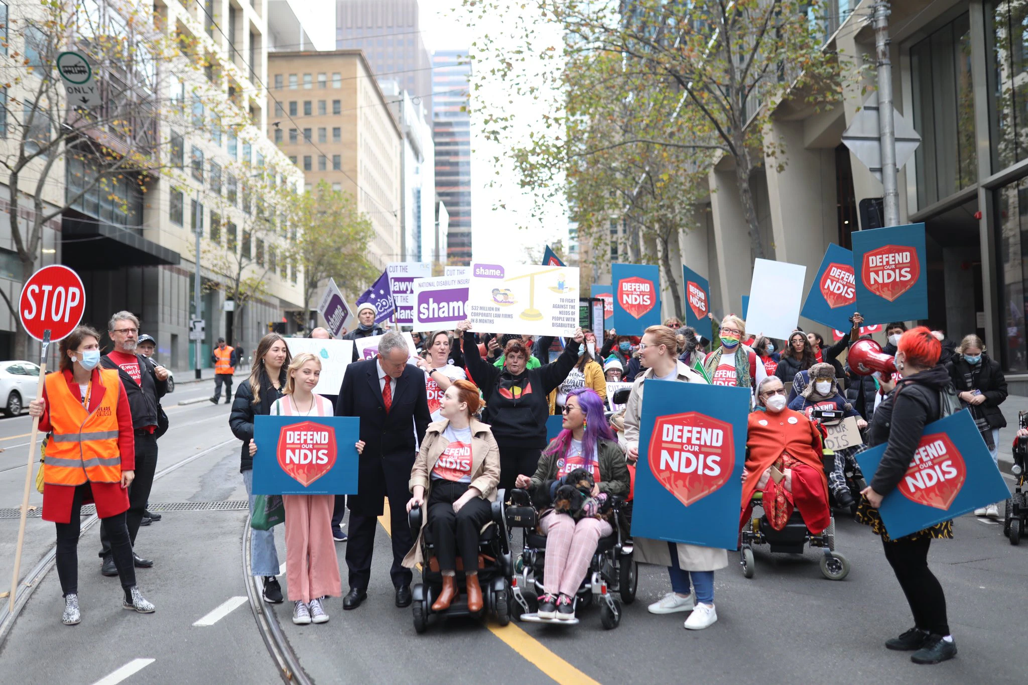 A group of advocates march in the Every Australian Counts Defend our NDIS rally in Melbourne's CBD.