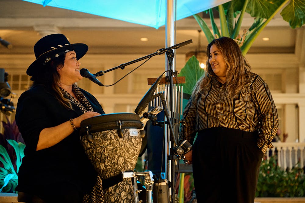 Entrepreneurs Jenn “JRoQ” Wright & Quinn Miyashiro talking to each other on a stage.