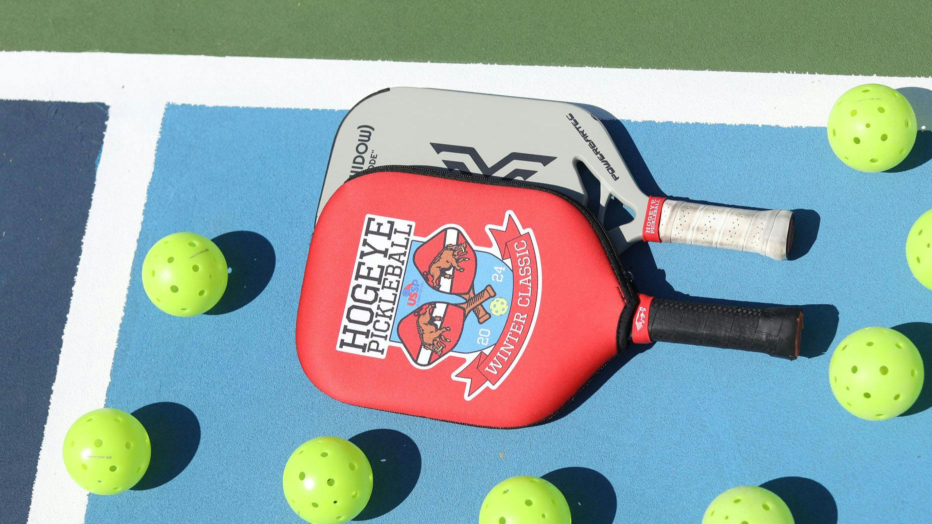 Pickleball paddles and balls on a court